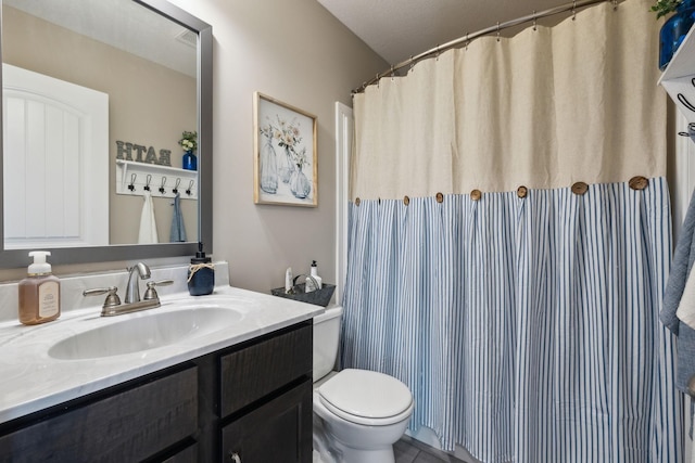 bathroom with toilet and vanity