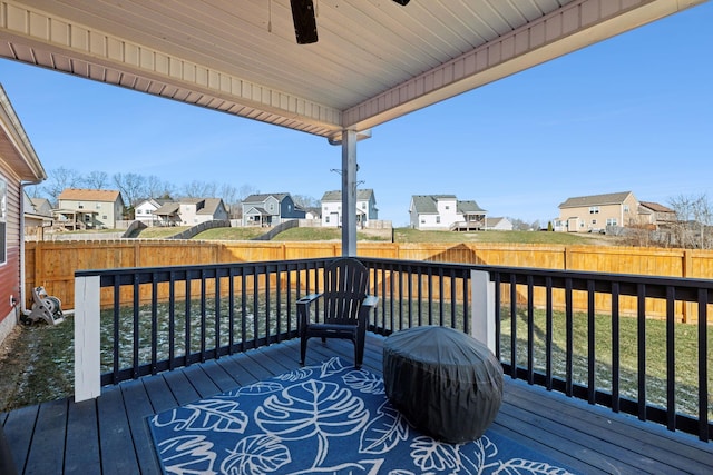 wooden deck featuring ceiling fan, a yard, and area for grilling