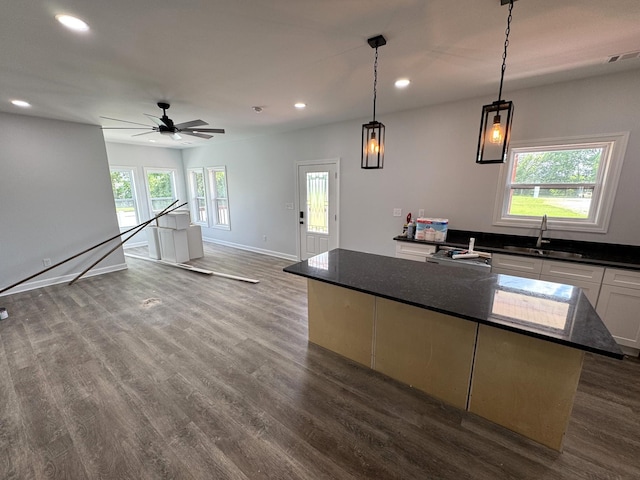 906 Davidson St, Tullahoma, TN 37388 - kitchen with a sink, recessed lighting, dark wood-style flooring, white cabinetry, and a center island