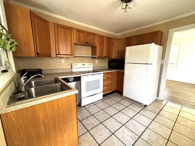 kitchen with crown molding, light tile patterned floors, sink, and white appliances