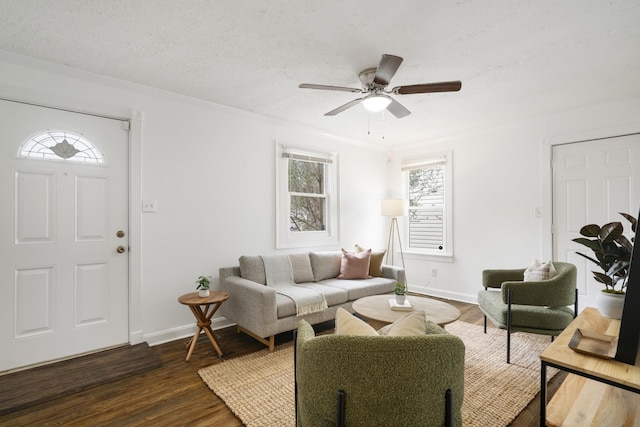 living room featuring ceiling fan, dark hardwood / wood-style floors, and a textured ceiling