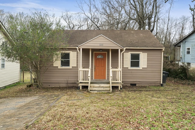 bungalow-style home with a front yard