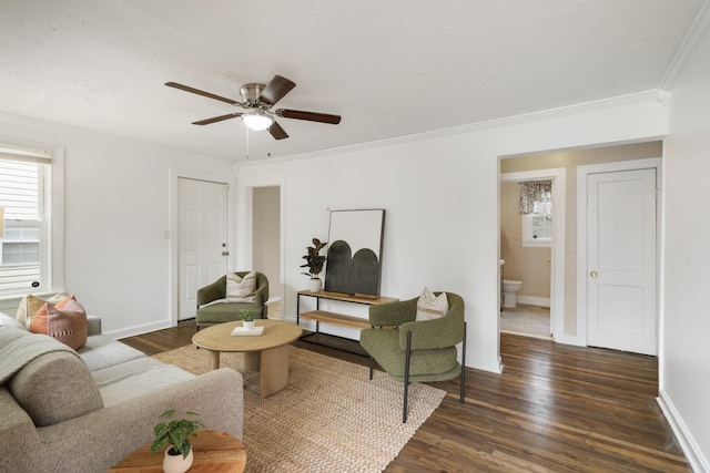 living room with dark hardwood / wood-style flooring, ornamental molding, and ceiling fan