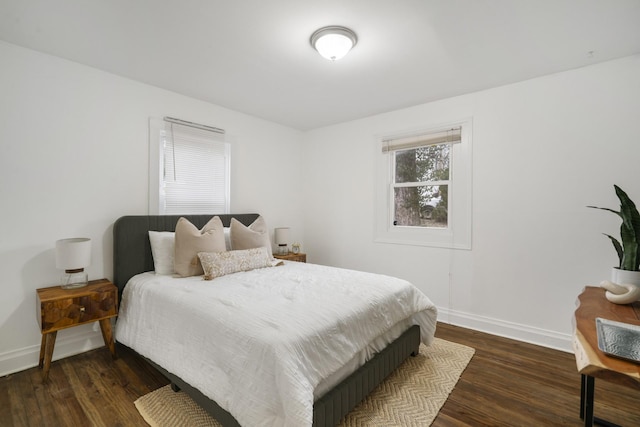 bedroom with dark wood-type flooring