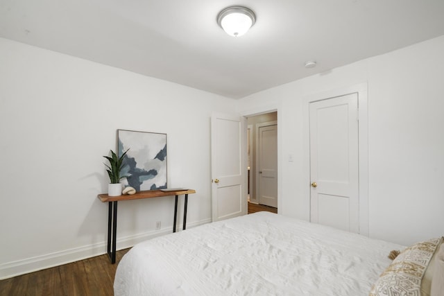 bedroom with dark wood-type flooring