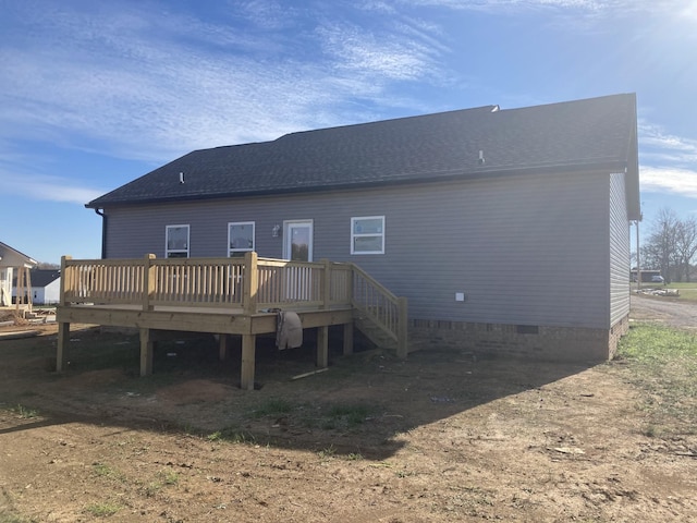 back of property with a wooden deck