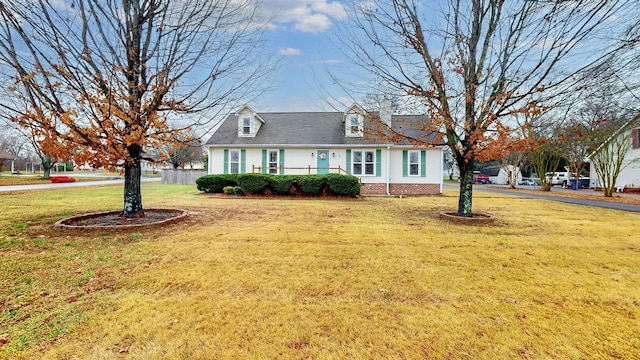 cape cod-style house featuring a front lawn