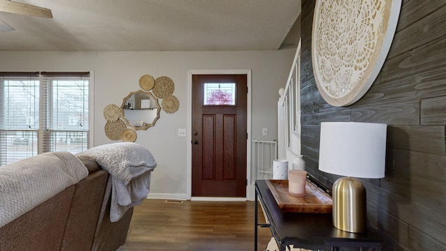 foyer featuring a healthy amount of sunlight and dark wood-type flooring