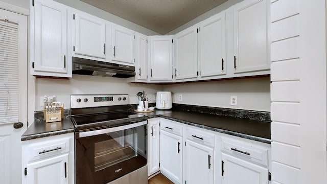 kitchen featuring stainless steel electric stove, a textured ceiling, and white cabinets