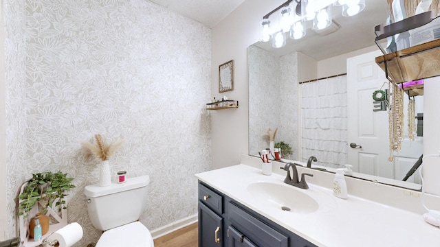 bathroom with wood-type flooring, toilet, and vanity