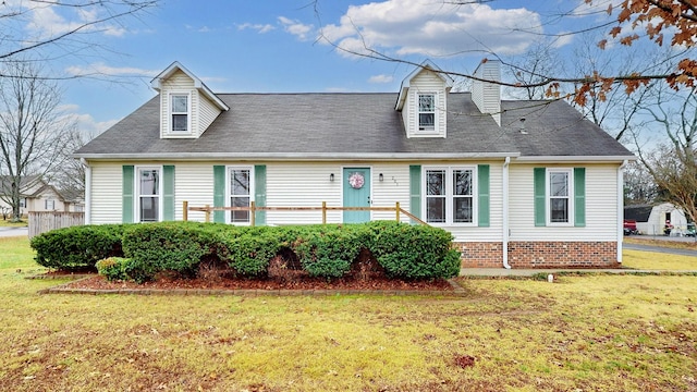 cape cod home with a front yard