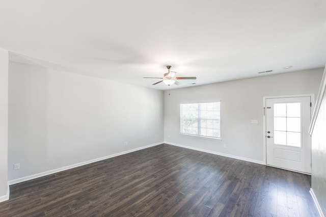 spare room featuring ceiling fan and dark hardwood / wood-style flooring