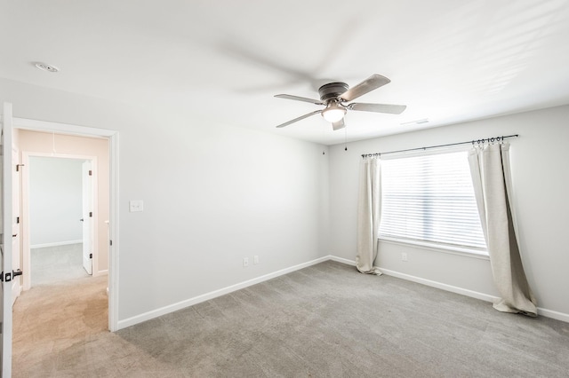 spare room featuring ceiling fan and light colored carpet