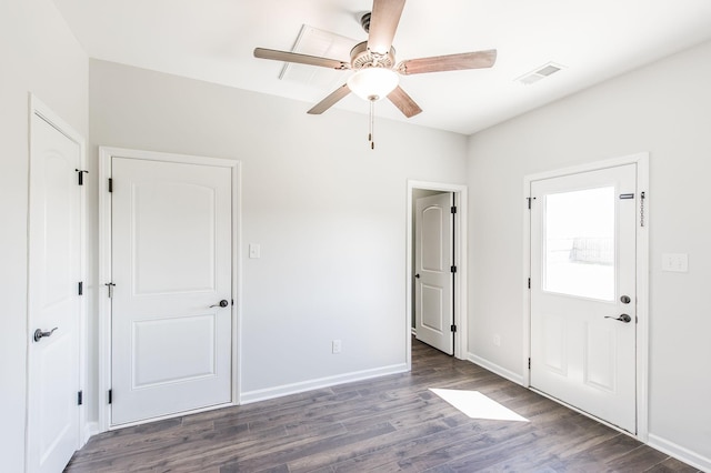 unfurnished bedroom with ceiling fan and dark hardwood / wood-style flooring