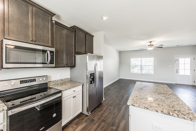 kitchen featuring ceiling fan, stainless steel appliances, dark hardwood / wood-style floors, white cabinets, and light stone counters