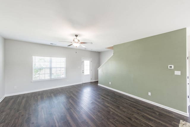 empty room featuring ceiling fan and dark wood-type flooring