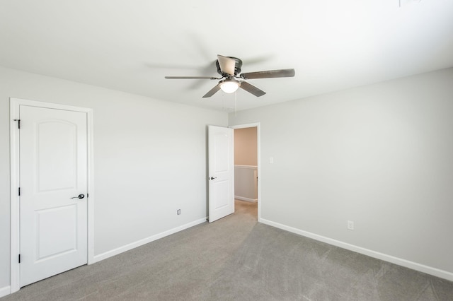 spare room featuring light carpet and ceiling fan