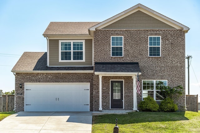 view of front of house with a front yard and a garage