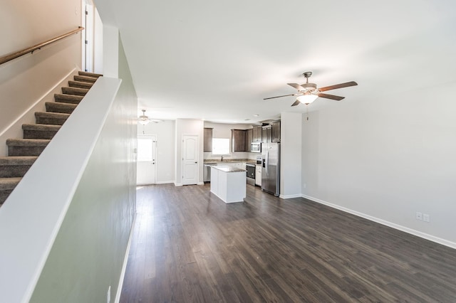 unfurnished living room with ceiling fan and dark hardwood / wood-style floors