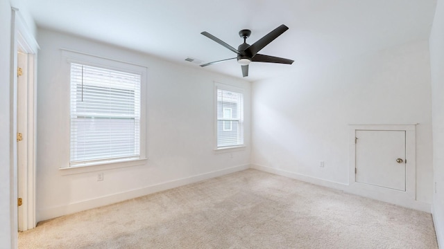 carpeted spare room featuring ceiling fan