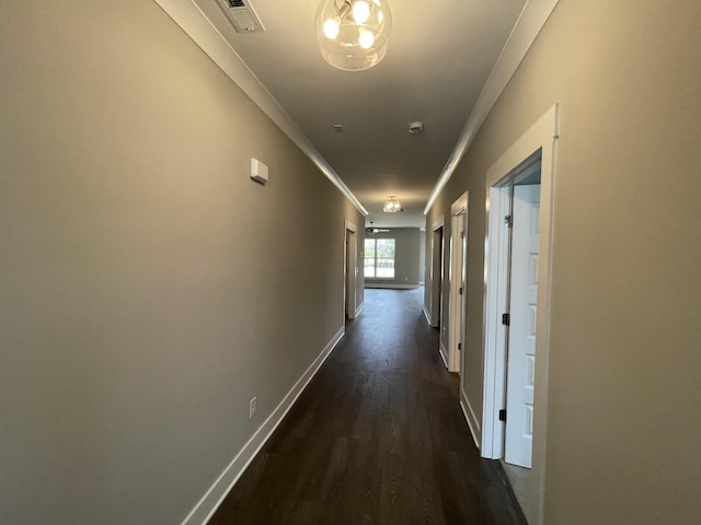 hall featuring ornamental molding and dark hardwood / wood-style floors