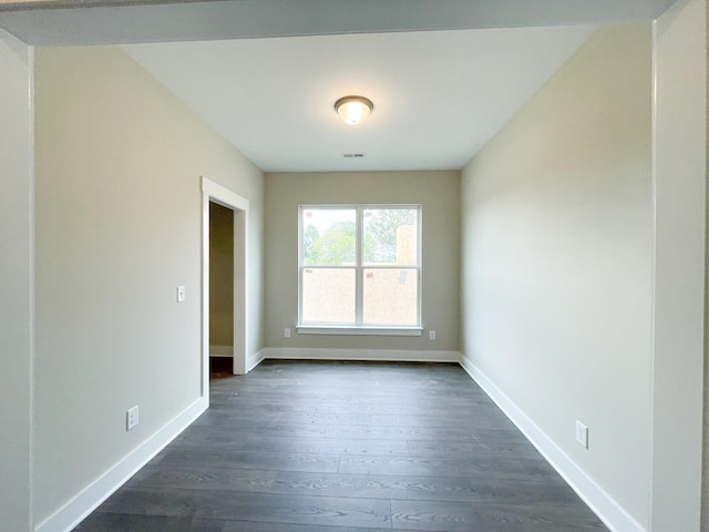 empty room with dark wood-type flooring