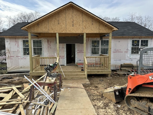 unfinished property featuring covered porch