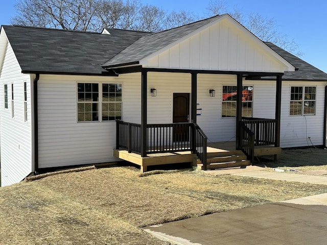 view of front of property featuring covered porch and a shingled roof