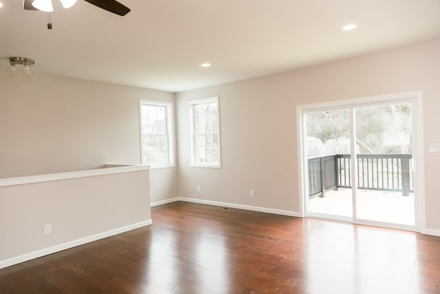 empty room with recessed lighting, baseboards, plenty of natural light, and wood finished floors