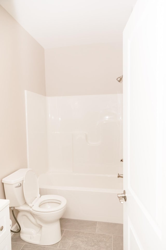 full bath featuring vanity, toilet, washtub / shower combination, and tile patterned flooring