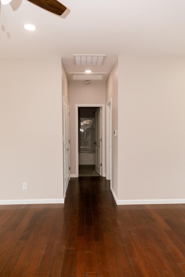 corridor with recessed lighting, visible vents, baseboards, and hardwood / wood-style floors