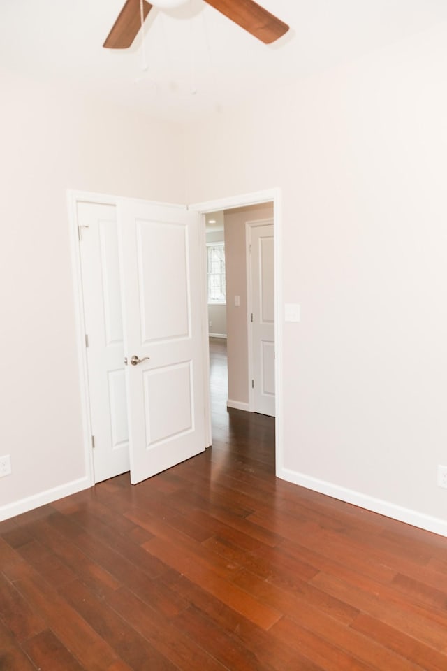 unfurnished room with baseboards, wood-type flooring, and ceiling fan