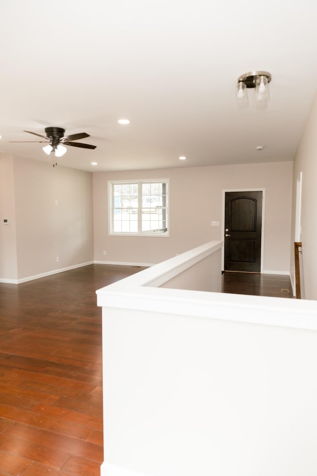 spare room with recessed lighting, baseboards, dark wood-style floors, and a ceiling fan