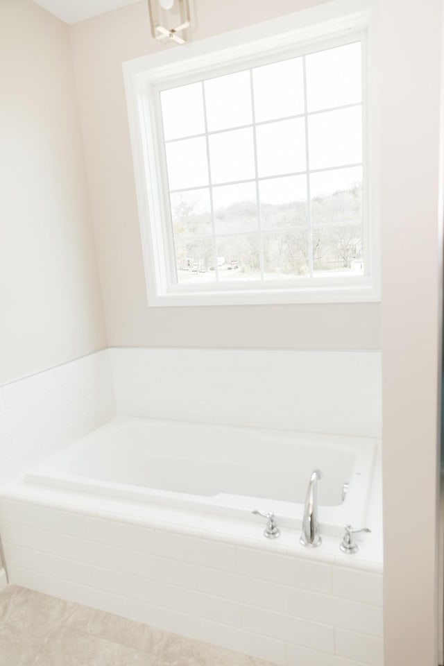 full bath featuring a wealth of natural light and a garden tub