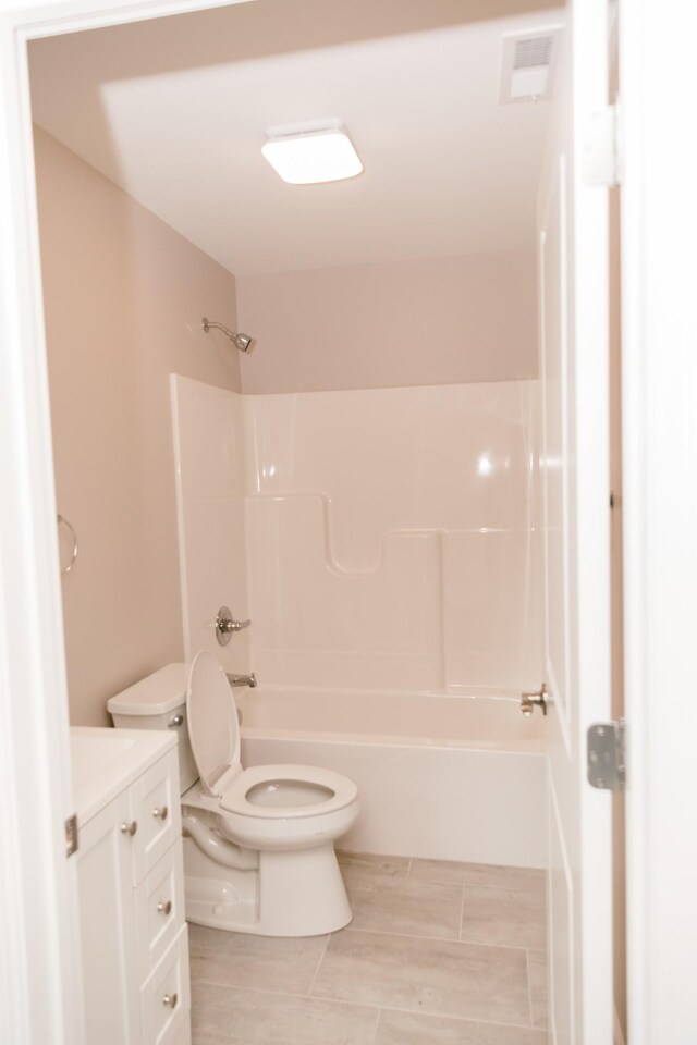 bathroom featuring visible vents, vanity, toilet, and shower / bathing tub combination