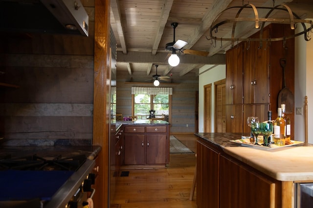 kitchen with ceiling fan, wood ceiling, beamed ceiling, and light hardwood / wood-style flooring