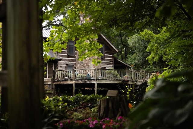 back of property featuring a wooden deck