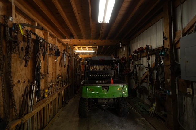 rec room with concrete floors and electric panel