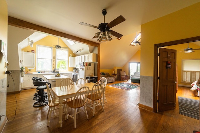 dining room with ceiling fan, dark hardwood / wood-style flooring, and lofted ceiling with beams