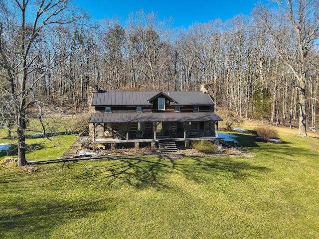 back of property with a yard and a porch