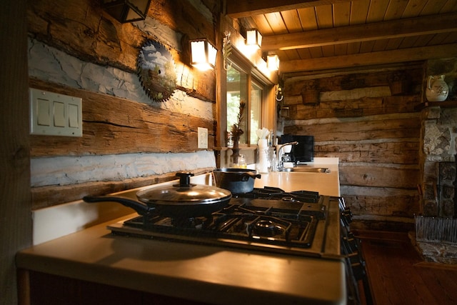 kitchen with wooden ceiling, sink, and beamed ceiling