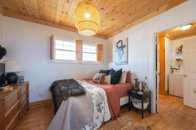 bedroom with washer / clothes dryer, wood ceiling, and light hardwood / wood-style flooring