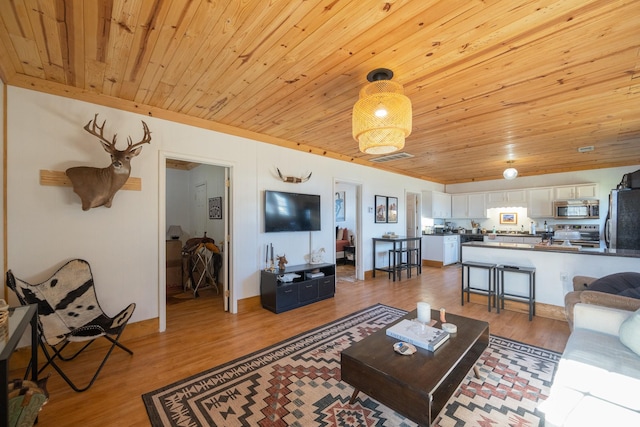 living room with wooden ceiling and light hardwood / wood-style flooring