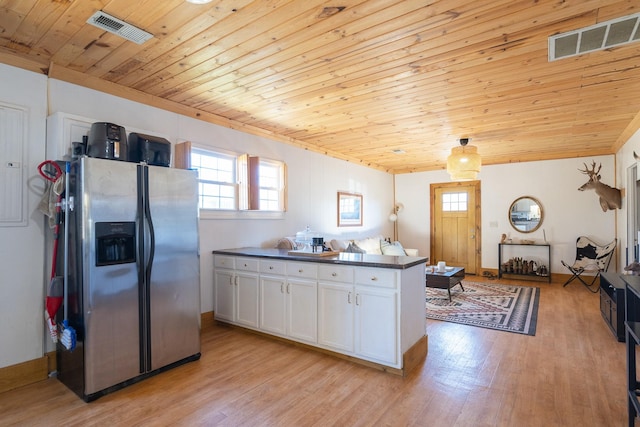 kitchen with white cabinets, wooden ceiling, stainless steel fridge, and light hardwood / wood-style floors