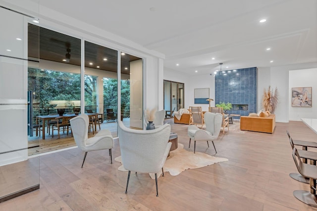 interior space with recessed lighting, a fireplace, and wood finished floors