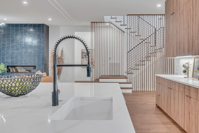 interior space with light wood-style floors, light brown cabinetry, a sink, and modern cabinets