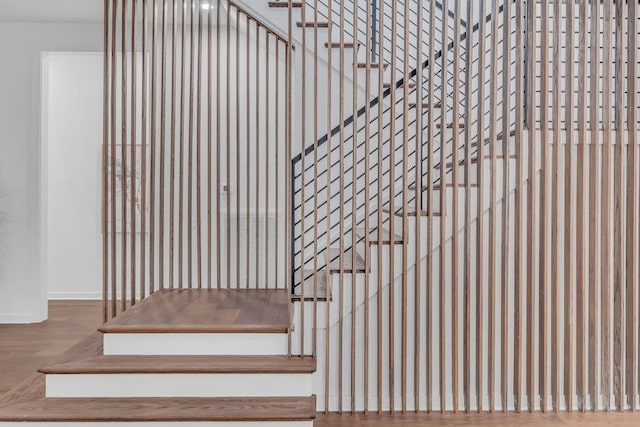 staircase featuring wood finished floors