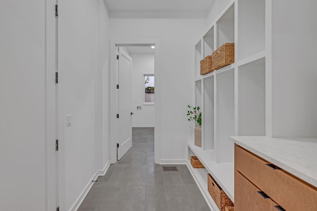 mudroom featuring visible vents, baseboards, and tile patterned floors