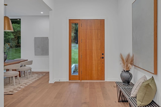 foyer entrance with recessed lighting, baseboards, and wood finished floors