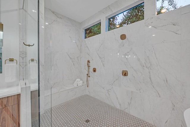 bathroom with a marble finish shower